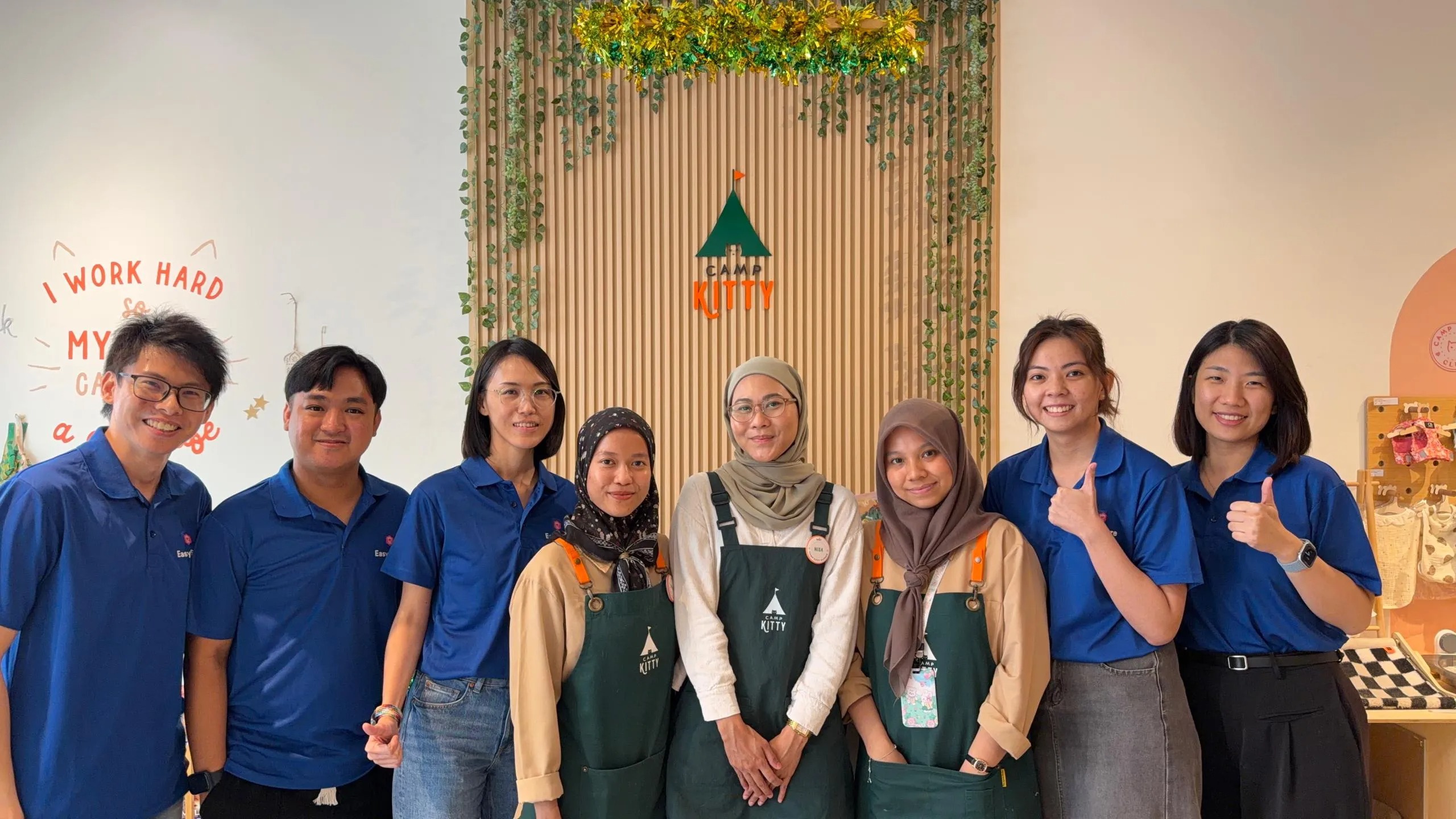 Camp Kitty and EasyStore teams at the store with the Camp Kitty brand sign