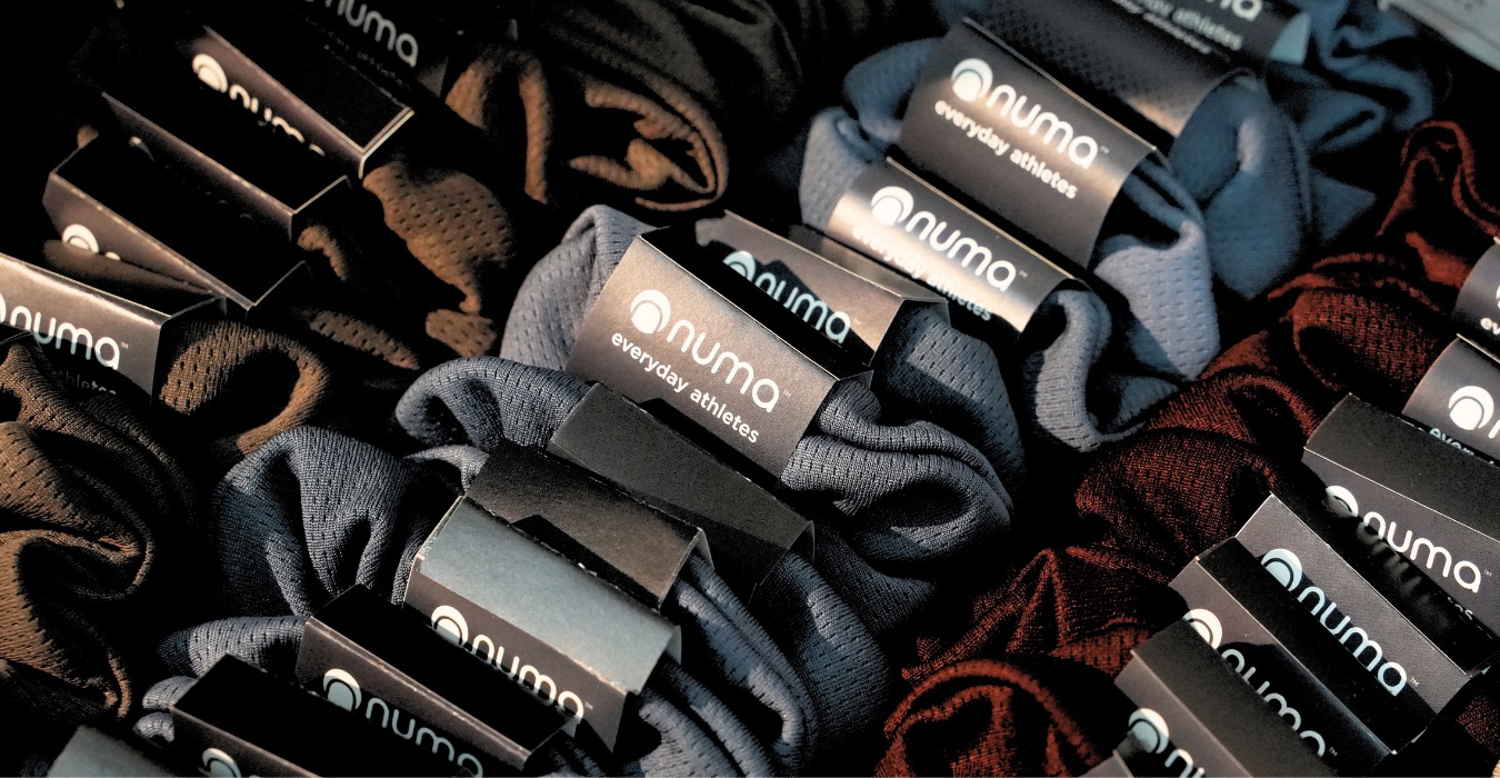 NUMA activewear with branded packaging and labels from its merchant story